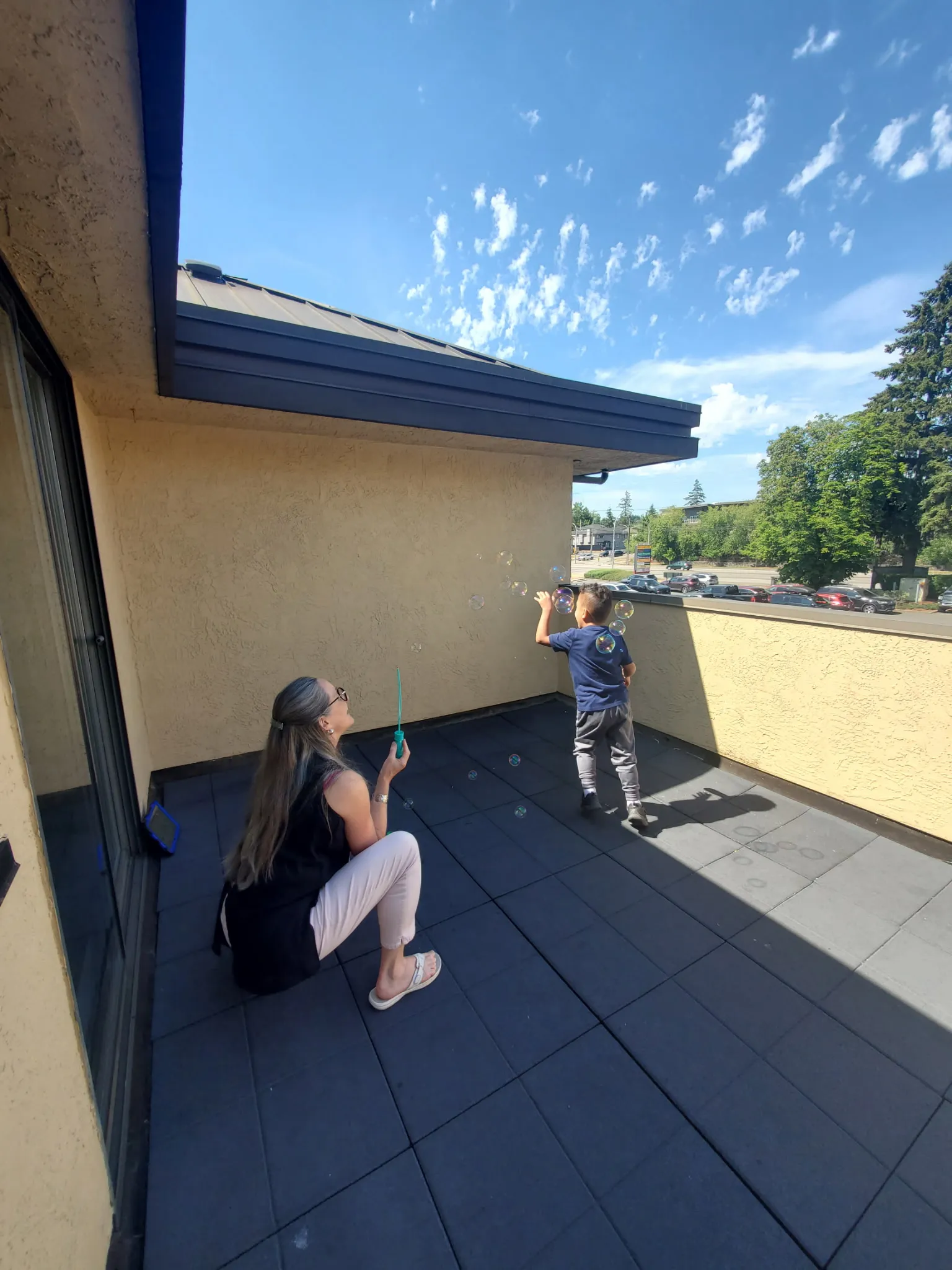 Heather and a patient blowing bubbles outside