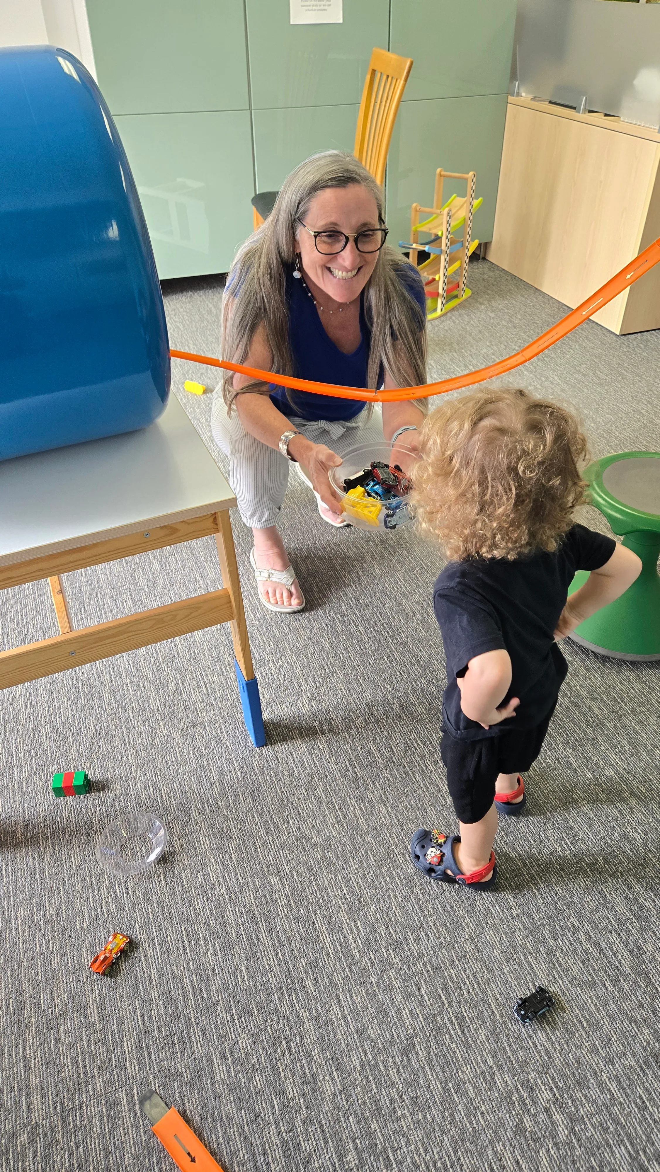 Heather cleaning hotwheels with a patient.